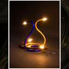 lámparas cisne escultura de luz instalacion en tubo-multicapa-negro encendida vista frontal Dimlightbcn Marino Robles Barcelona